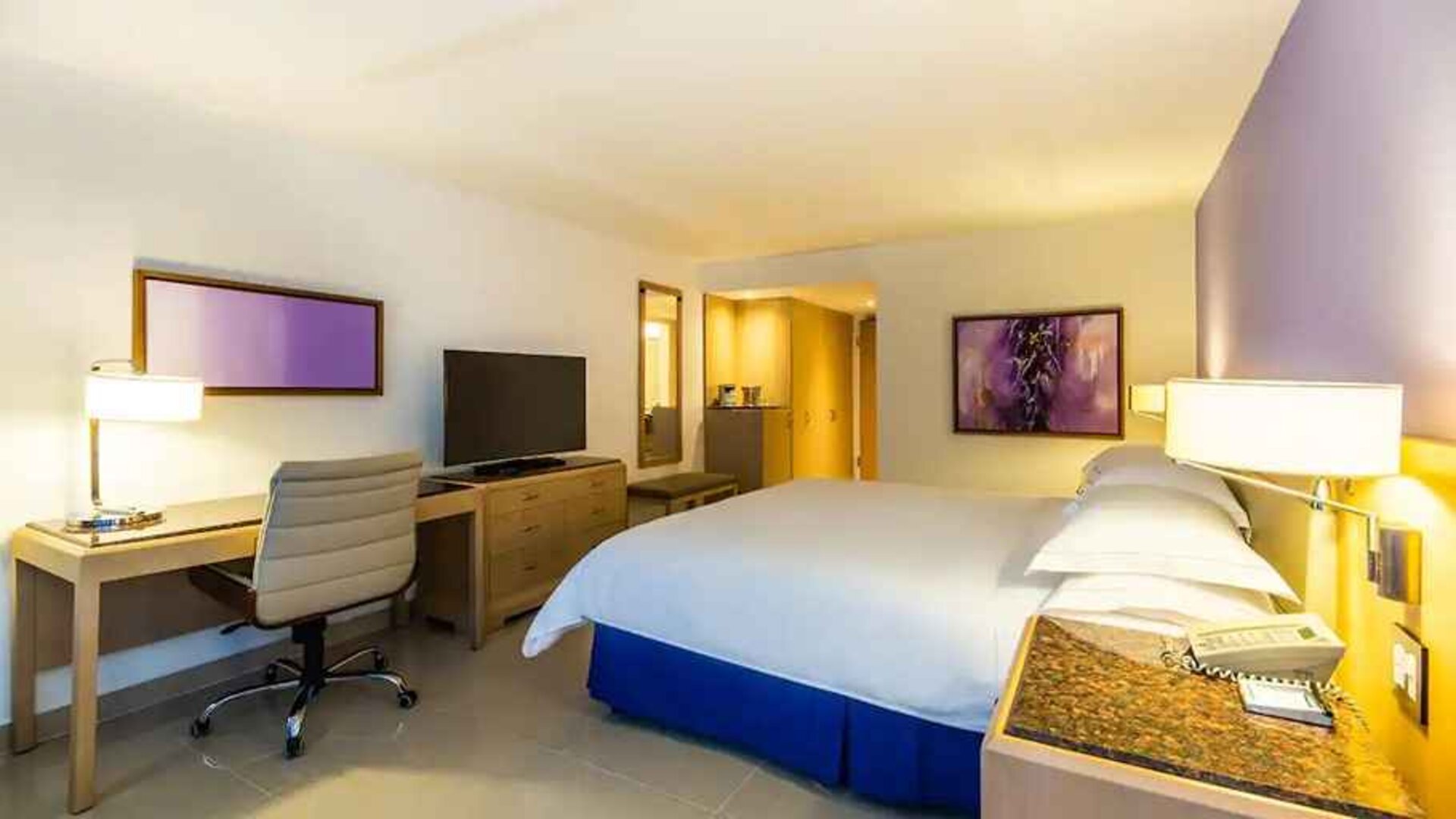 spacious king suite with TV and work desk at Hilton Cartagena Hotel.