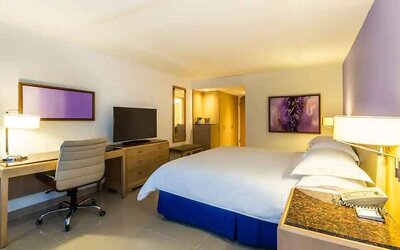 spacious king suite with TV and work desk at Hilton Cartagena Hotel.