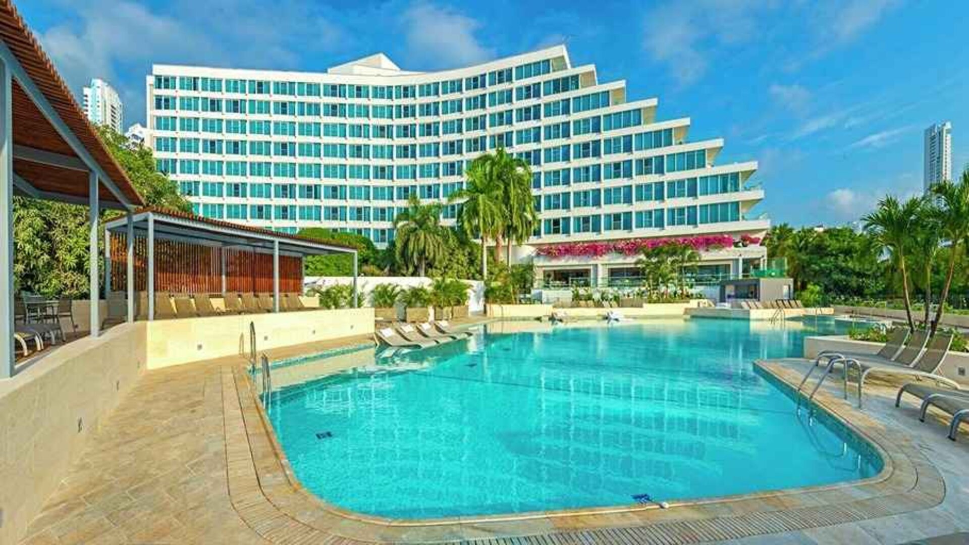 beautiful outdoor pool with sun beds at Hilton Cartagena Hotel.