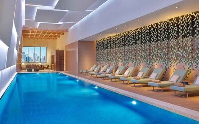 gorgeous indoor pool with pool beds at DoubleTree by Hilton Sharjah Waterfront Hotel & Residences.