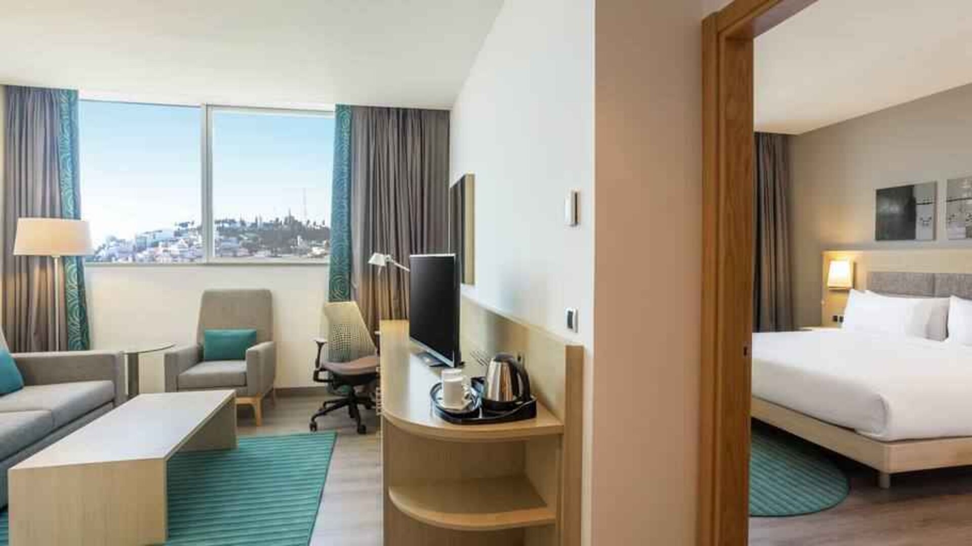 Hotel suite with living room and king size bed at the Hilton Garden Inn Tanger City Center.