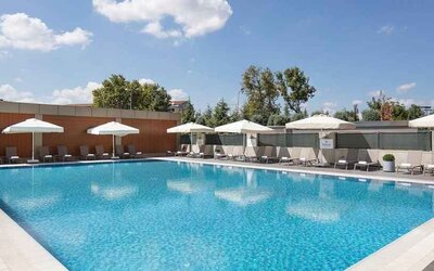 stunning outdoor pool with sun beds and umbrellas at Hilton Istanbul Bakirkoy.
