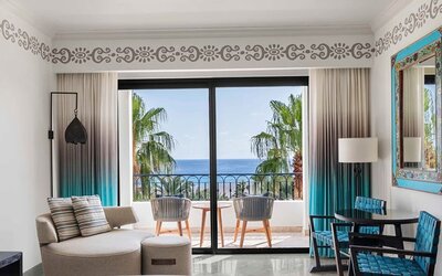 Living room with balcony perfect as workspace at the Hilton Los Cabos Beach & Golf Resort.