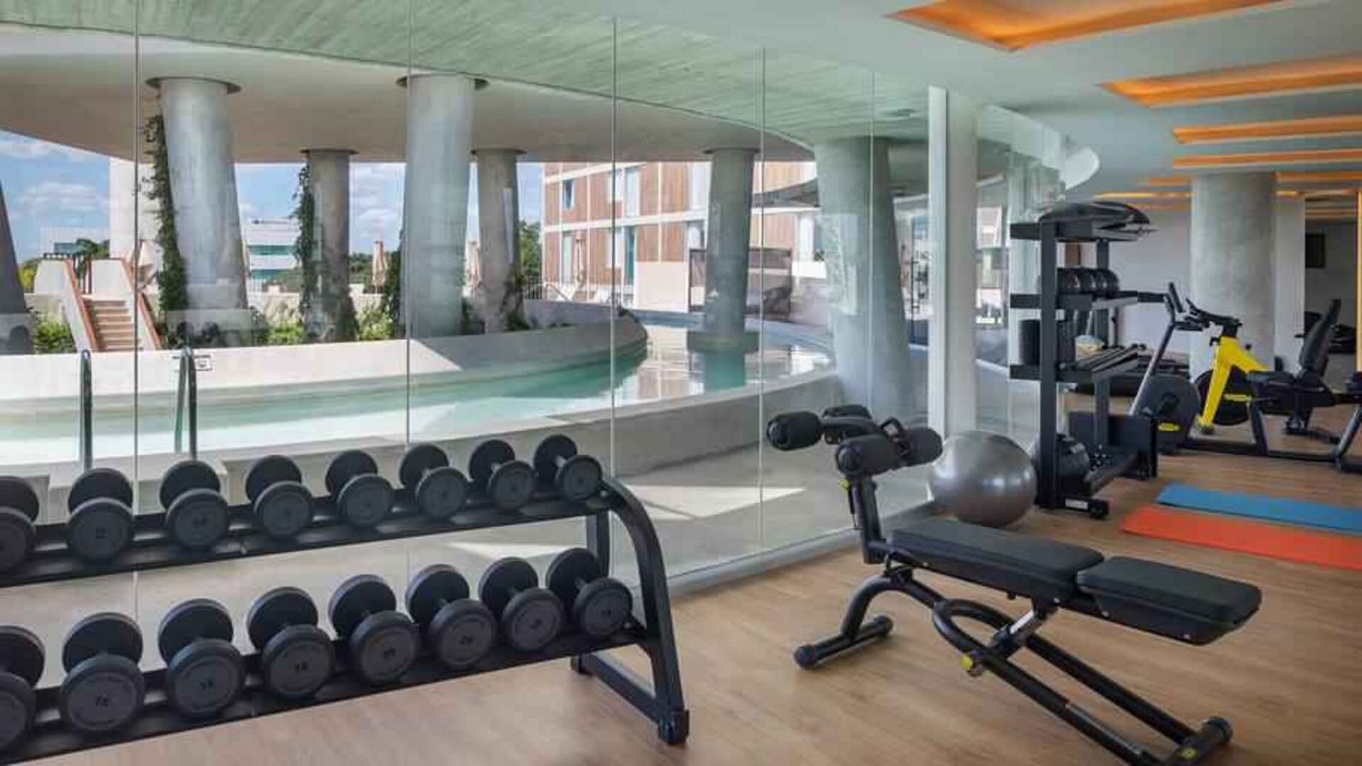 Fitness center with weights and machines at the Hilton Garden Inn Cancun Airport.