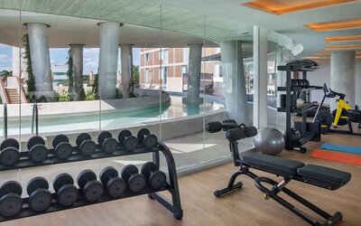 Fitness center with weights and machines at the Hilton Garden Inn Cancun Airport.