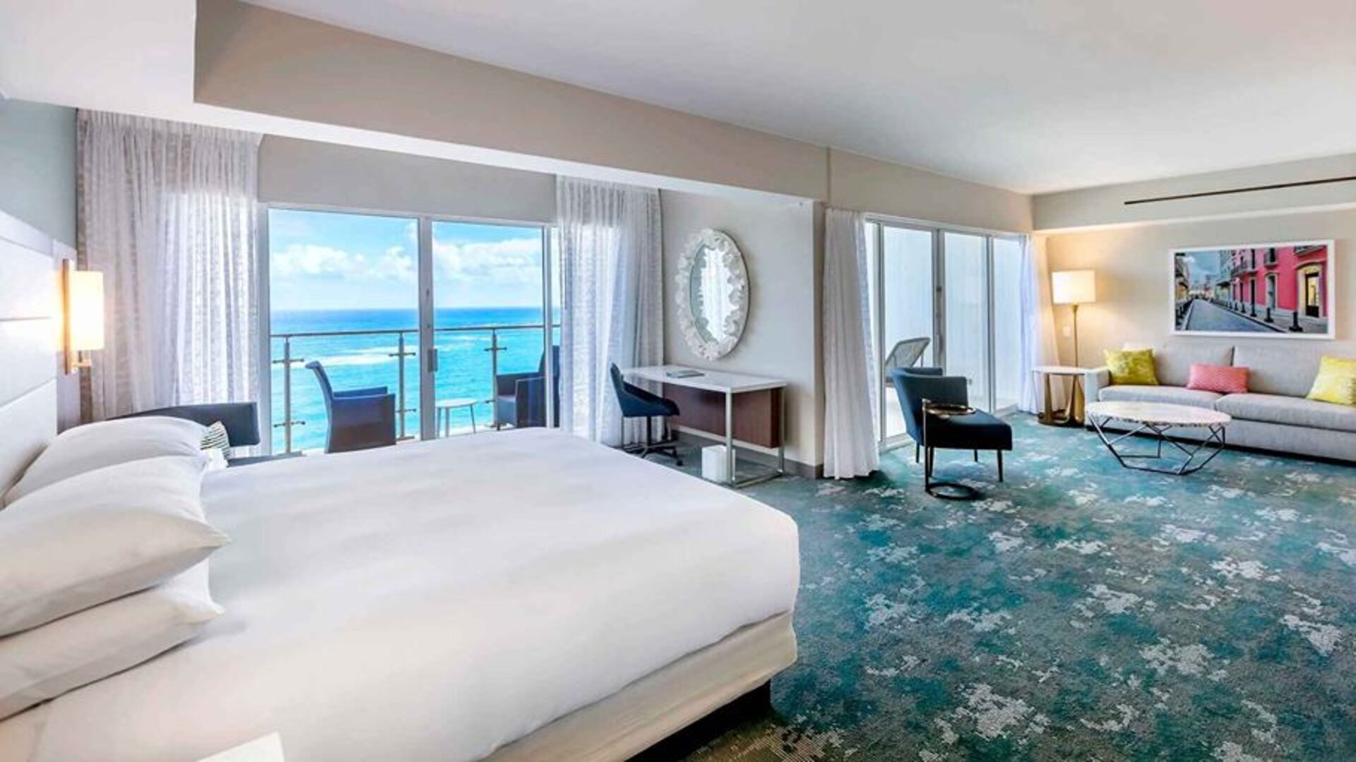 King suite with working station overlooking the sea at the Caribe Hilton.
