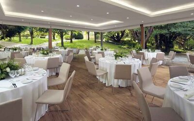 Dining area set in a beautful garden at the Boeira Garden Hotel Porto Gaia, Curio Collection by Hilton.