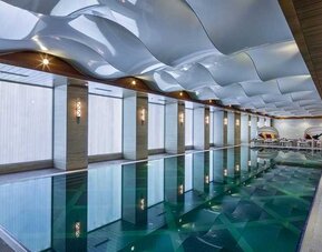 lovely indoor pool with seating area at DoubleTree by Hilton Istanbul Topkapi.