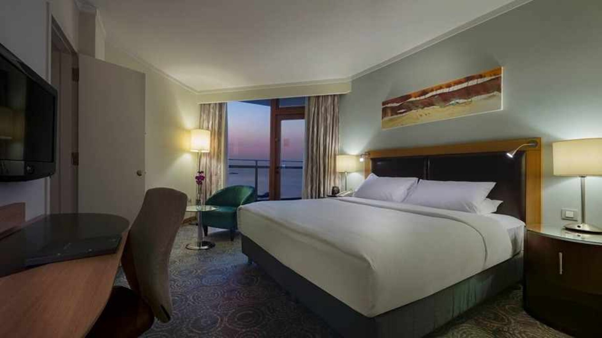 lovely king bedroom with TV, desk, and chair at Mersin HiltonSA.