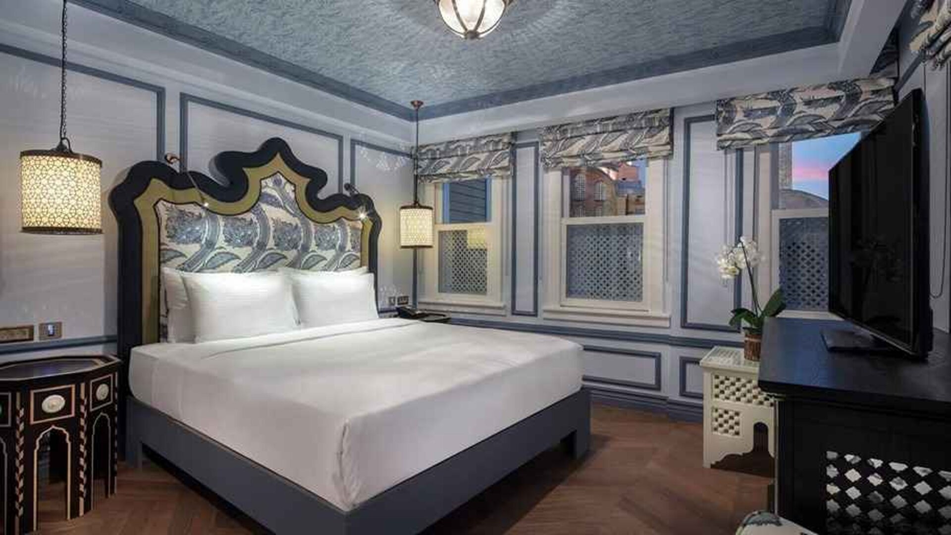 luxurious king bedroom with TV at Hagia Sofia Mansions Istanbul, Curio Collection by Hilton.