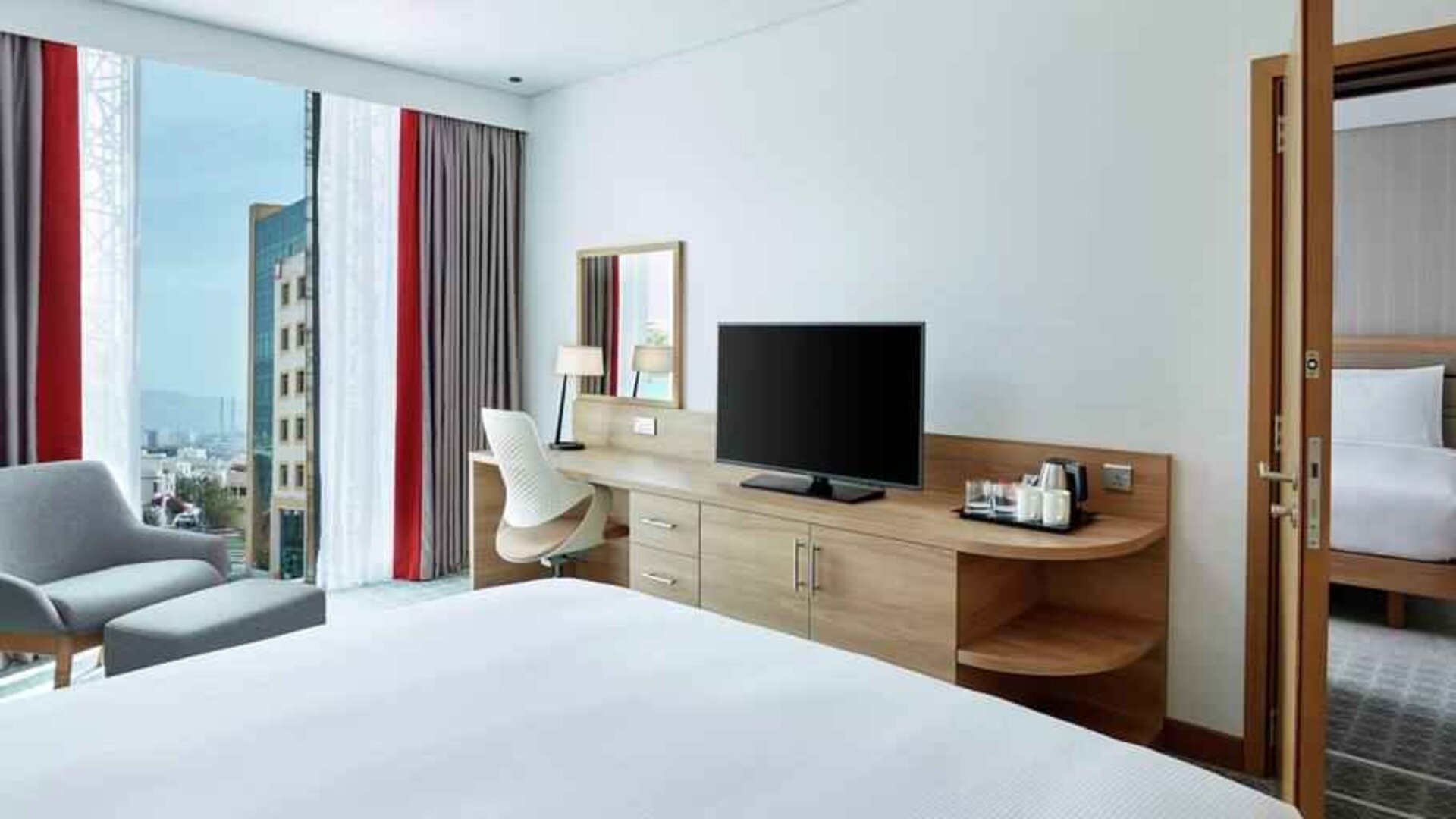 King suite with working station along the window at the Hilton Garden Inn Muscat Al Khuwair.