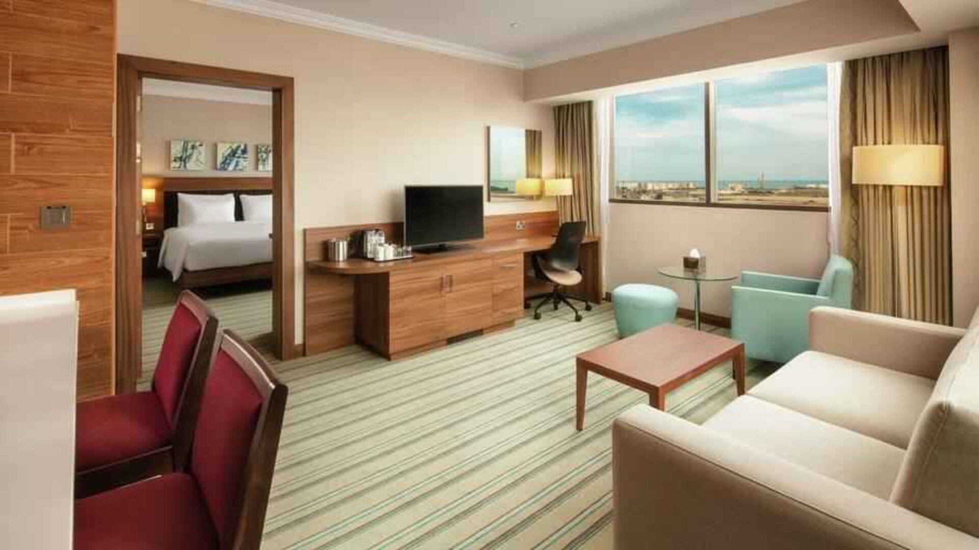 Living room with working station at the Hilton Garden Inn Al Jubail.