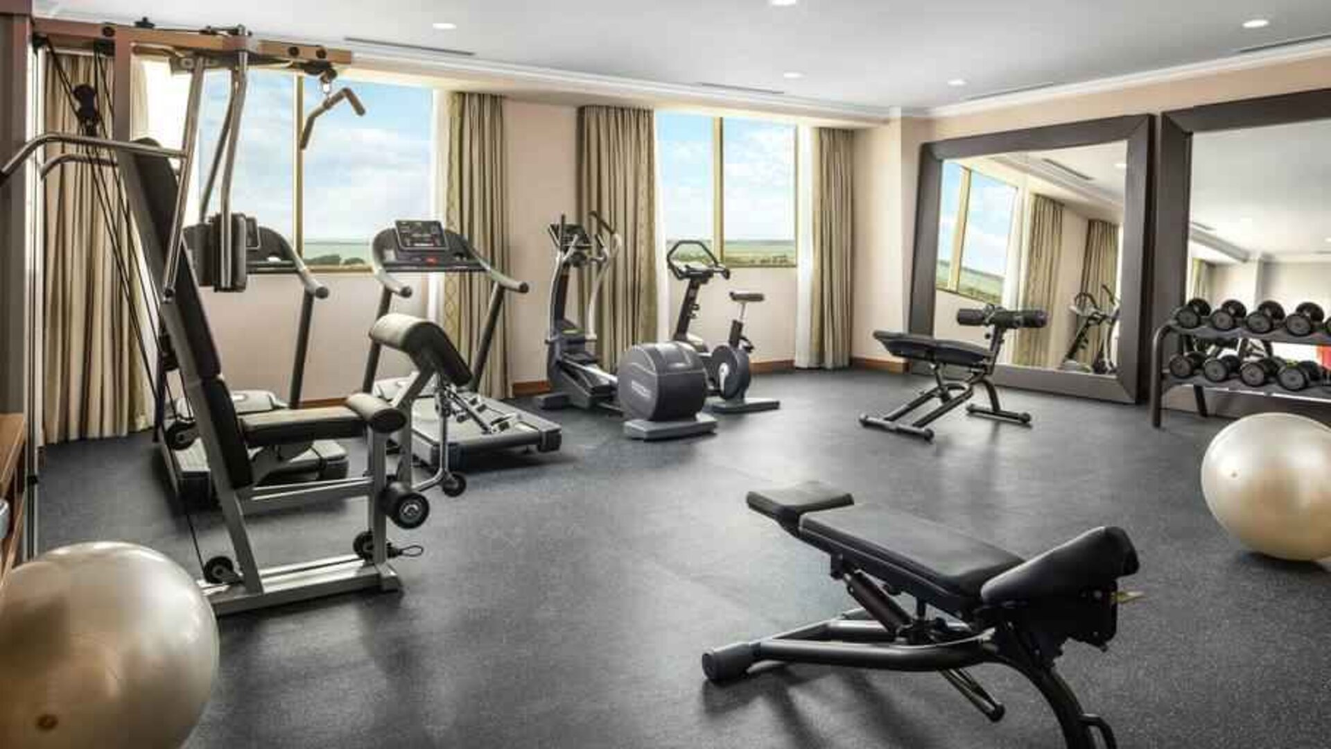 Bright fitness center with windows at the Hilton Garden Inn Al Jubail.