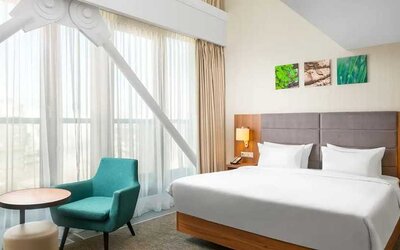 comfortable king room with couch at Hilton Garden Inn Bucharest Old Town.