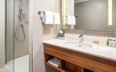 clean and spacious bathroom with shower at Hilton Garden Inn Bucharest Old Town.