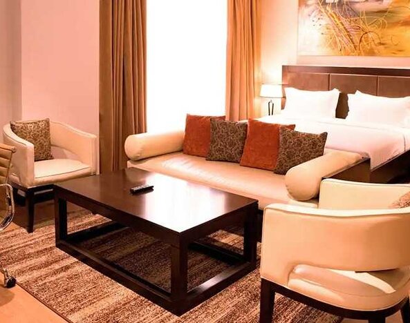luxurious king suite with lounge area, business desk, and chair at DoubleTree by Hilton Nairobi Hurlingham.