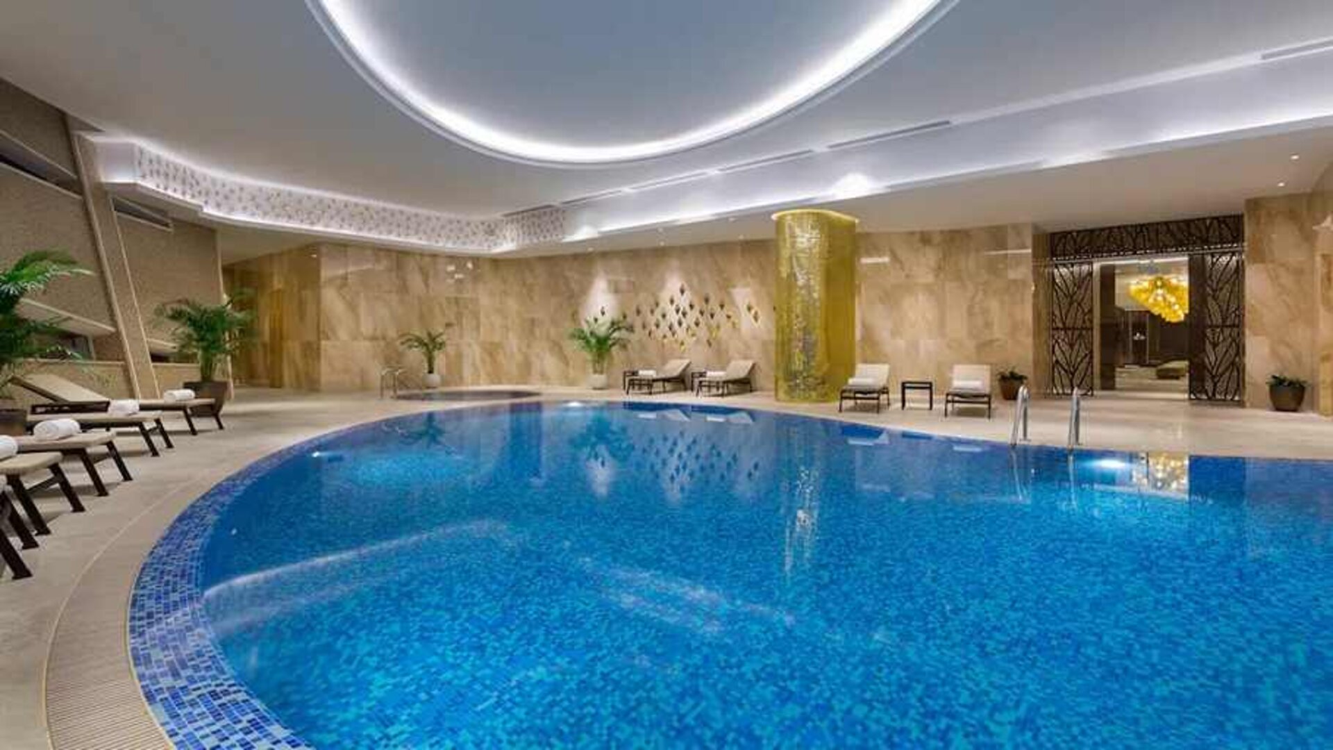stunning indoor pool with sunbeds at Hilton Astana.