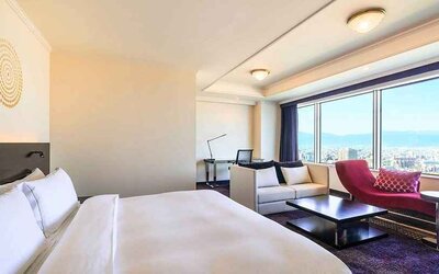 luxurious king suite with lounge area, business desk, and chair at Hilton Fukuoka Sea Hawk.
