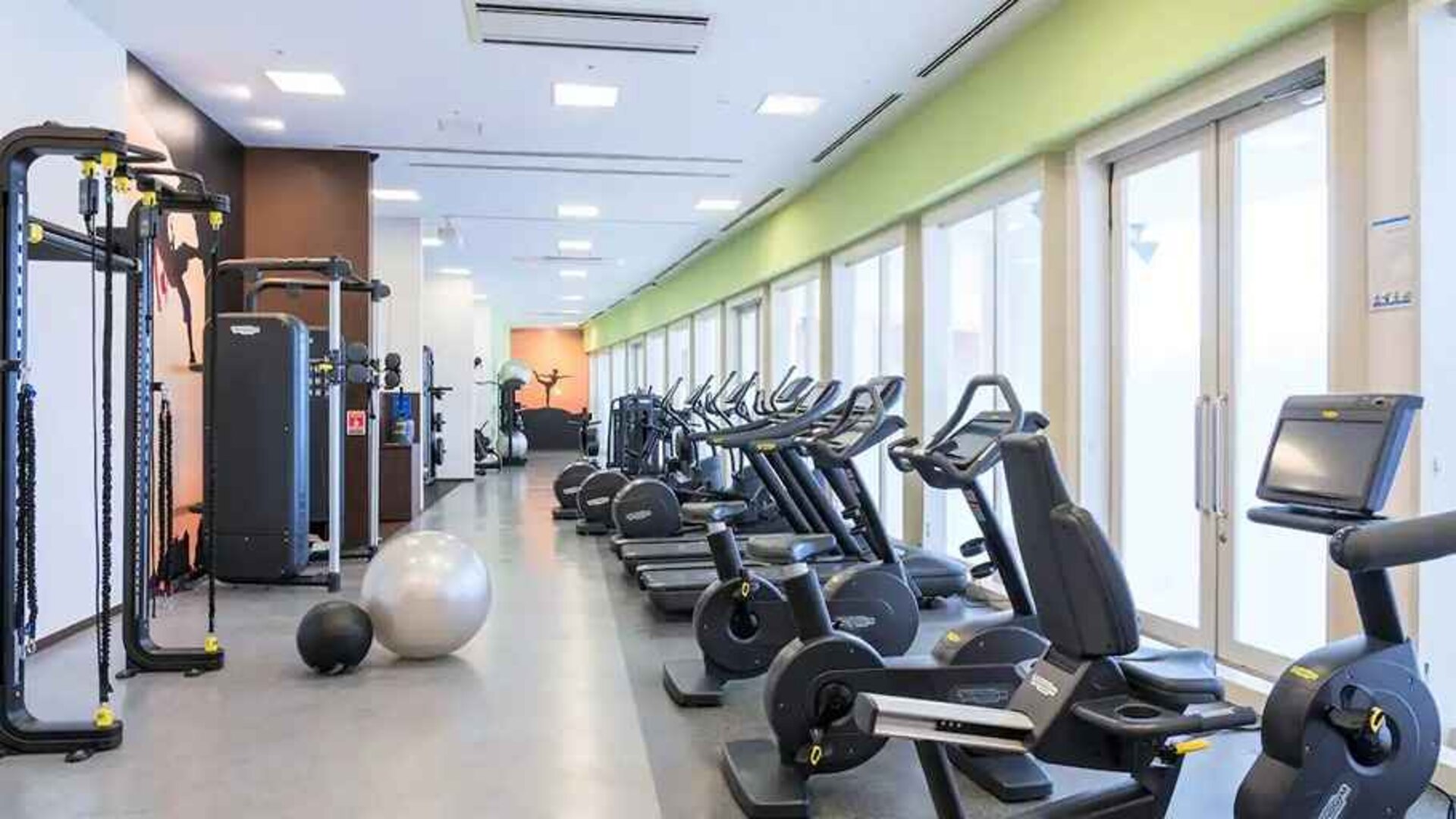well equipped fitness center with treadmills, bicycles, and weights at Hilton Fukuoka Sea Hawk.