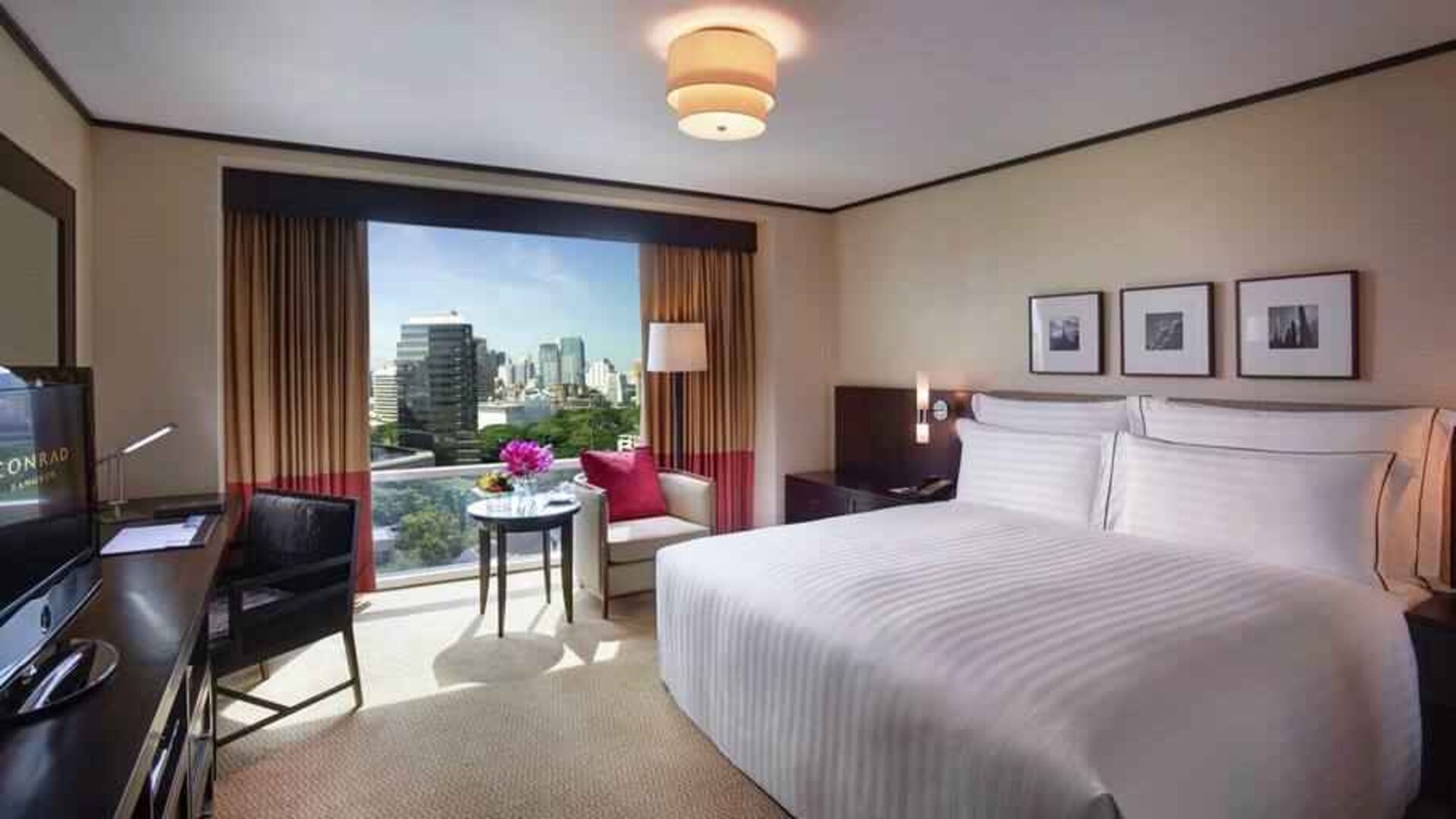 King bedroom with desk at the Conrad Bangkok.