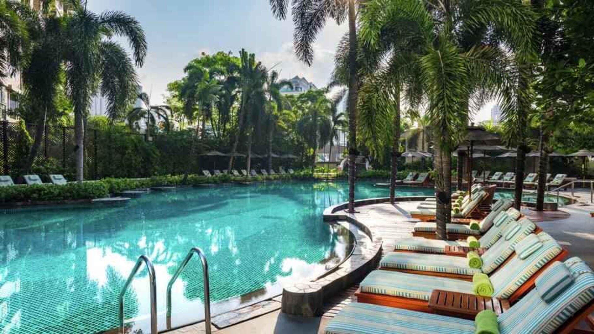Beautiful outdoor pool with lounges at the Conrad Bangkok.