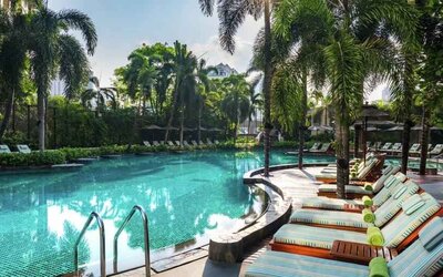 Beautiful outdoor pool with lounges at the Conrad Bangkok.