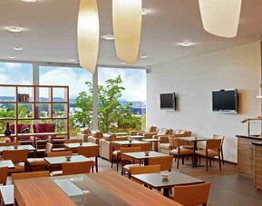 Seating area with TV screens at the Hilton Zurich Airport.