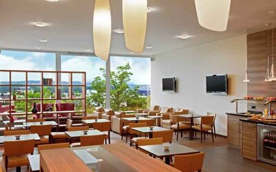 Seating area with TV screens at the Hilton Zurich Airport.