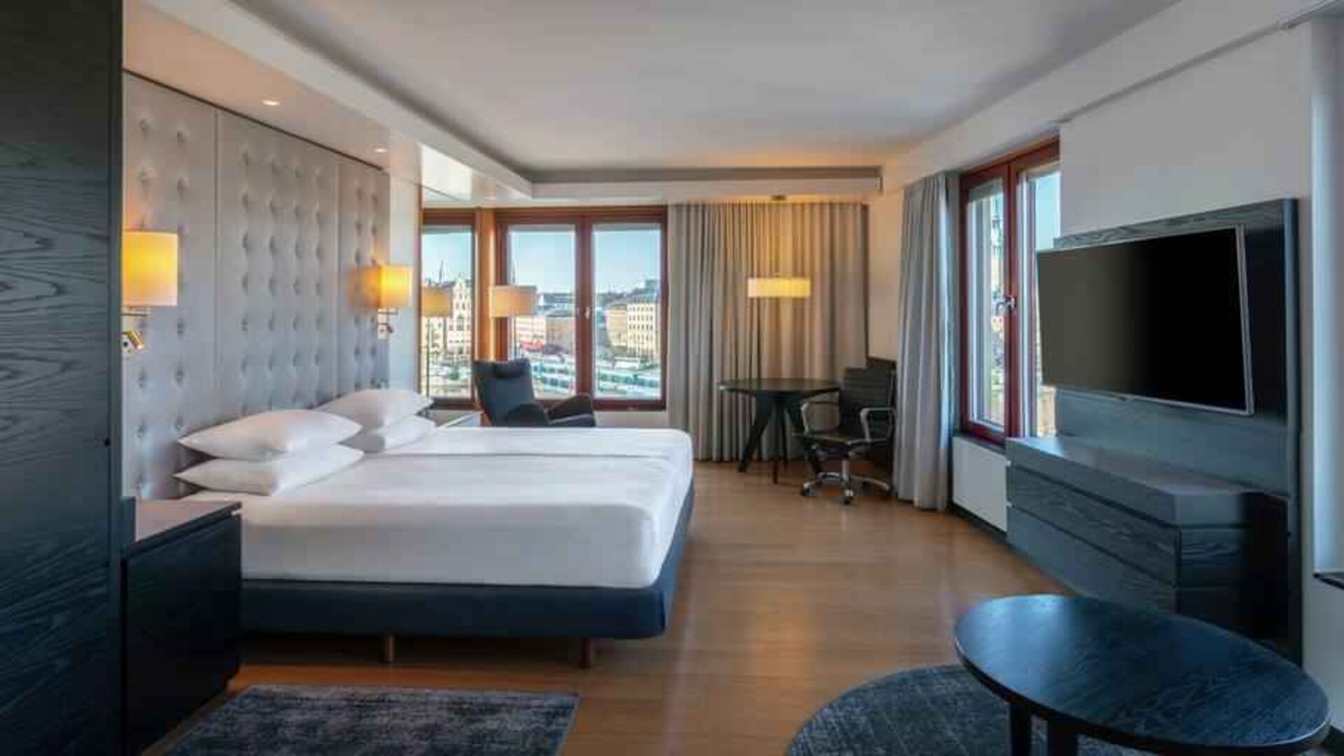 Spacious king suite with desk at the Hilton Stockholm Slussen.