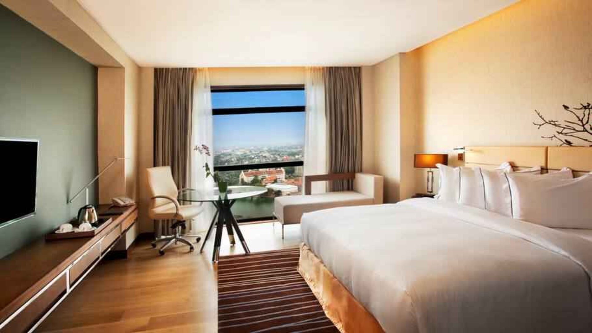 King guestroom with working station along the window at the Hilton Colombo Residence.