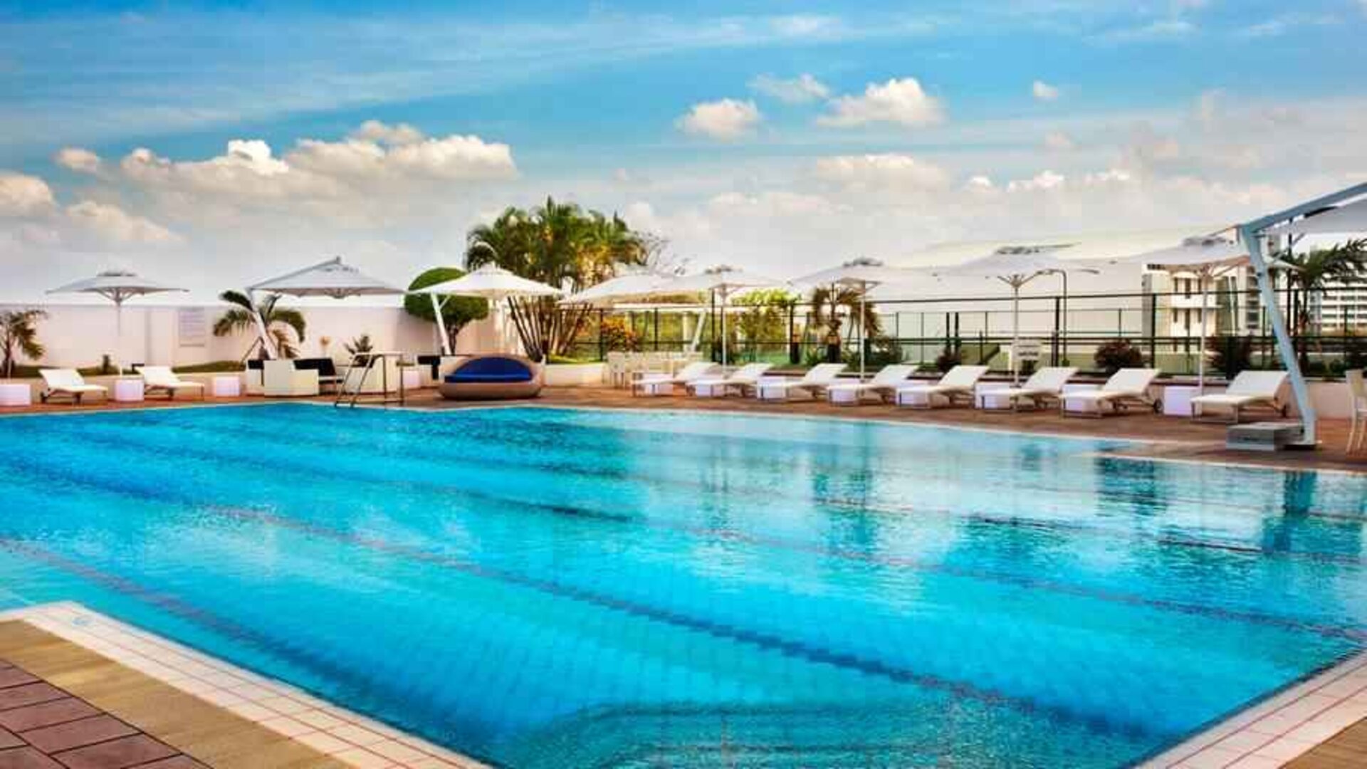 Relaxing outdoor pool area with lounges at the Hilton Colombo Residence.