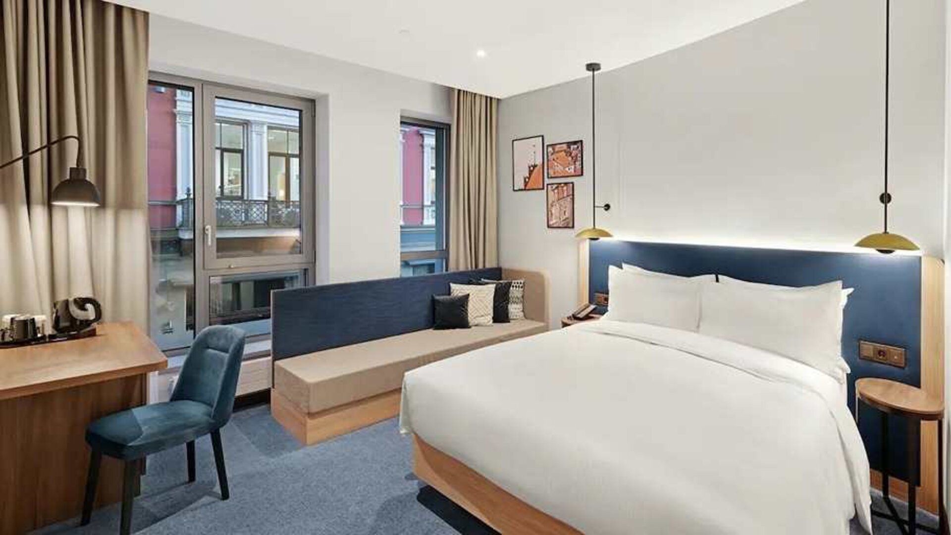 king room with chair, desk, and couch at Hilton Garden Inn Riga Old Town.