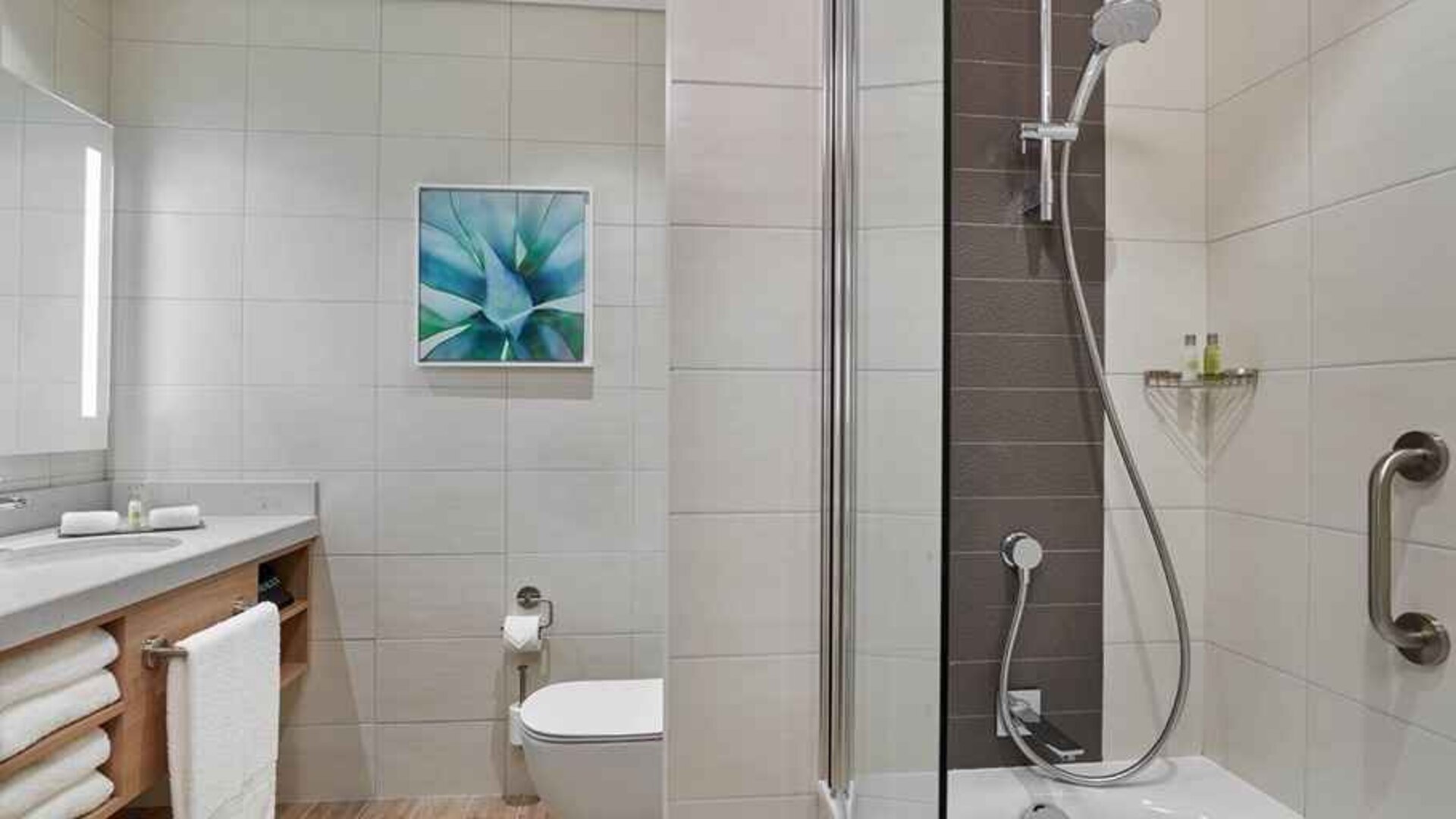 clean and spacious bathroom with shower and bath combo at Hilton Garden Inn Kuwait.