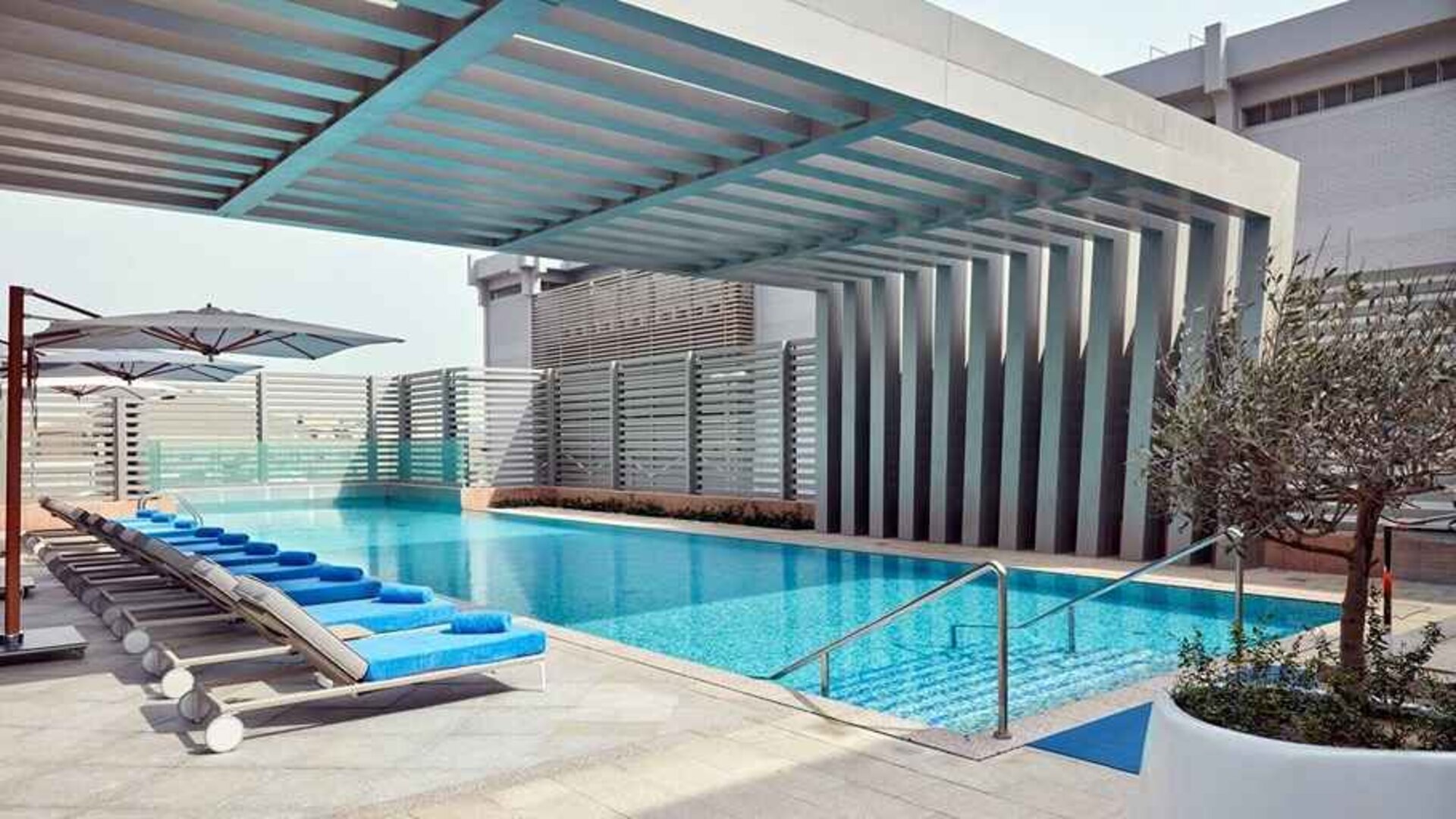 stunning outdoor pool with sunbeds at Hilton Garden Inn Kuwait.