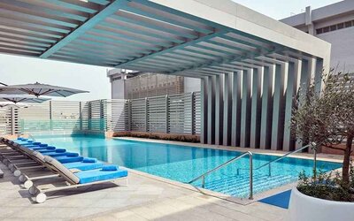 stunning outdoor pool with sunbeds at Hilton Garden Inn Kuwait.