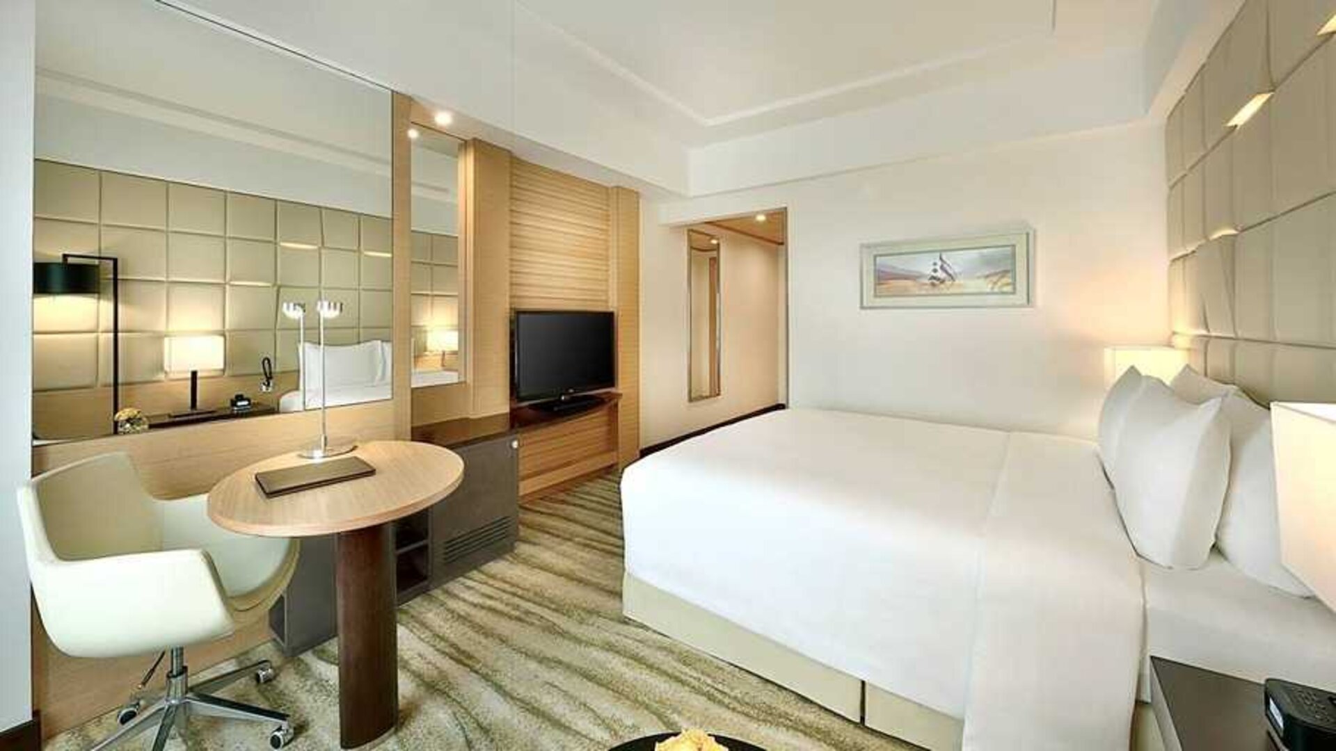 comfortable king room with TV, desk, and chair at DoubleTree by Hilton Riyadh - Al Muroj Business Gate.