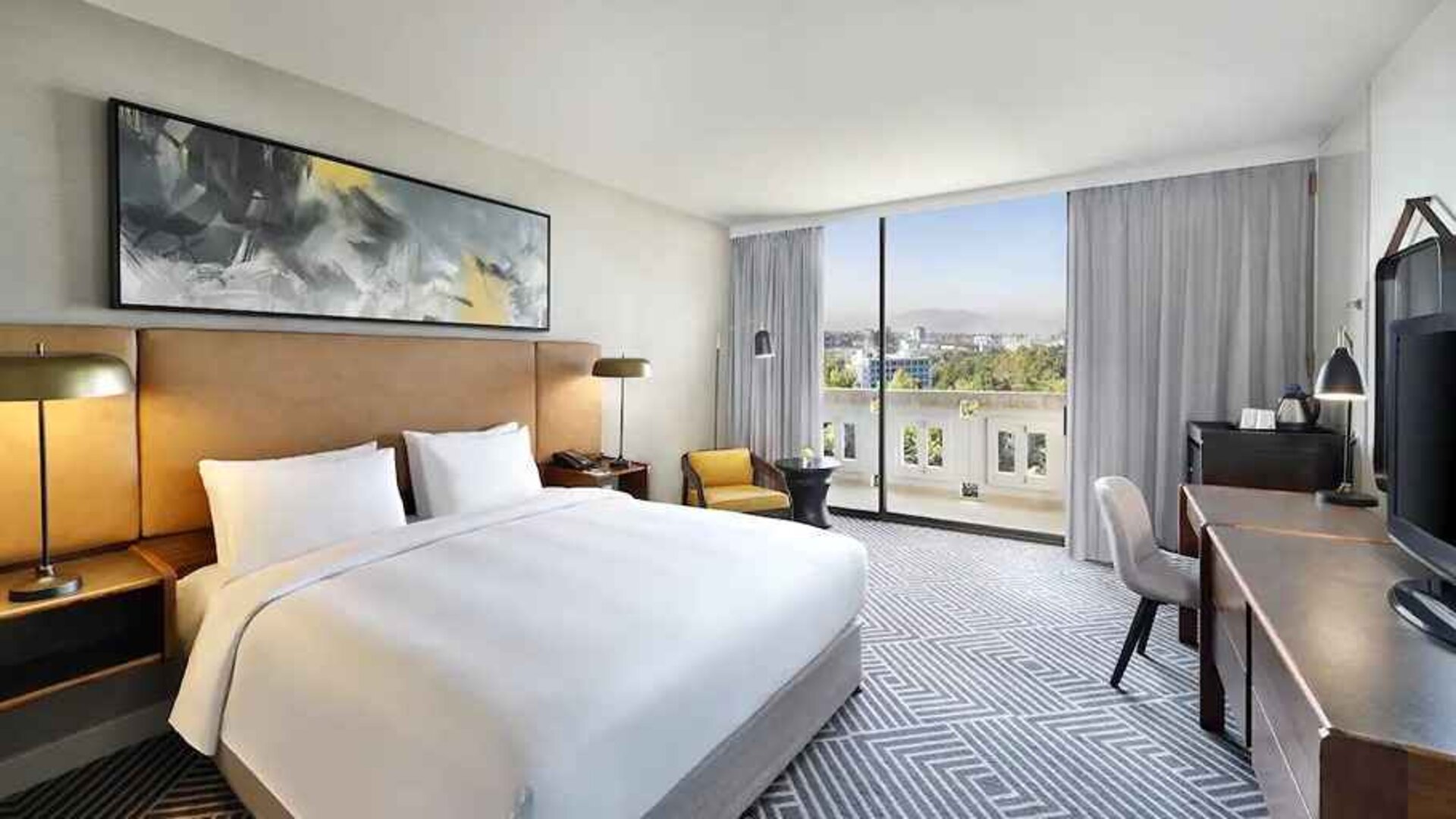 spacious king suite with TV, work desk and chair, and outside terrace at Hilton Addis Ababa.