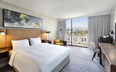 spacious king suite with TV, work desk and chair, and outside terrace at Hilton Addis Ababa.