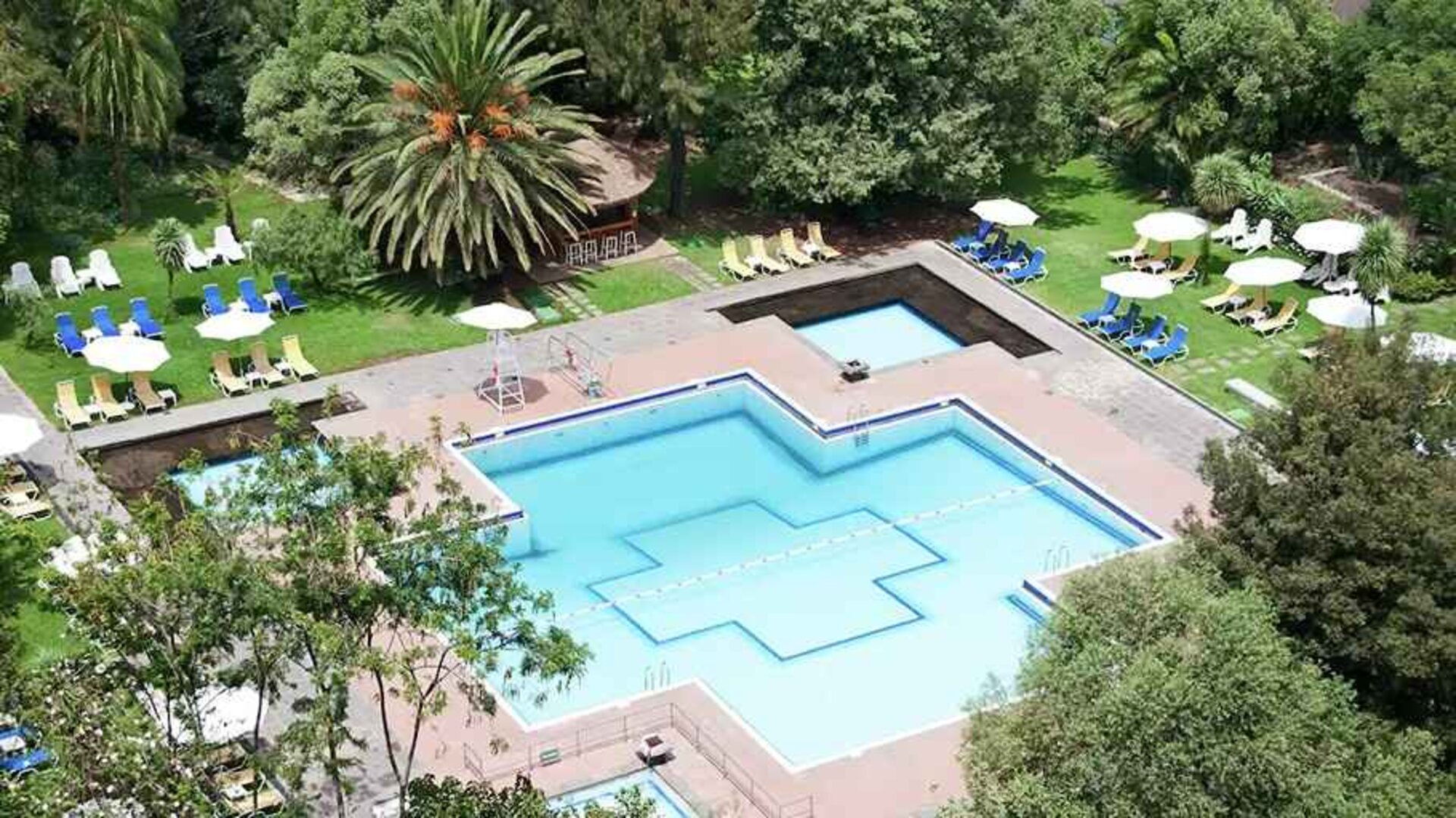 stunning outdoor pool with sun beds and umbrellas at Hilton Addis Ababa.