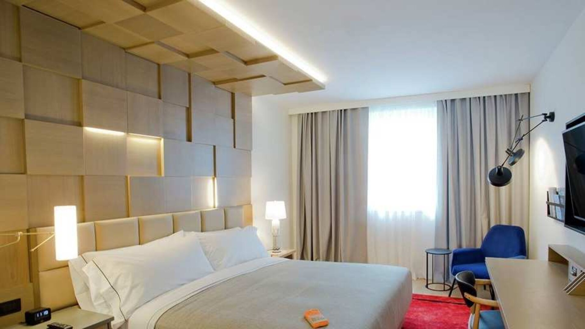 delux king room with TV, work desk, and chair at Canopy by Hilton Zagreb City Centre.