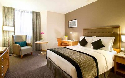 delux king room with desk, chair, couch, and TV at DoubleTree by Hilton Luxembourg.