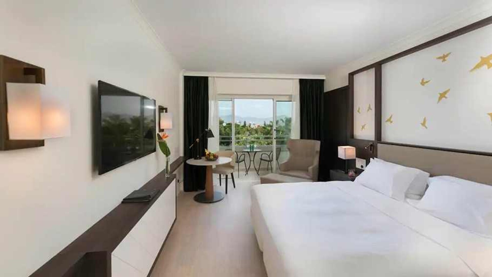 comfortable king room with TV and outdoor terrace at Hilton Nicosia.