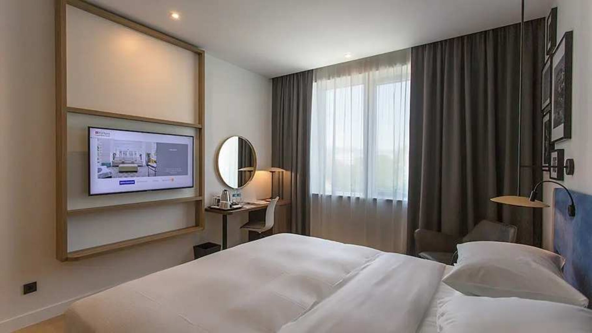 comfortable king suite with TV, work desk, and chair at Hilton Garden Inn Zagreb - Radnicka.