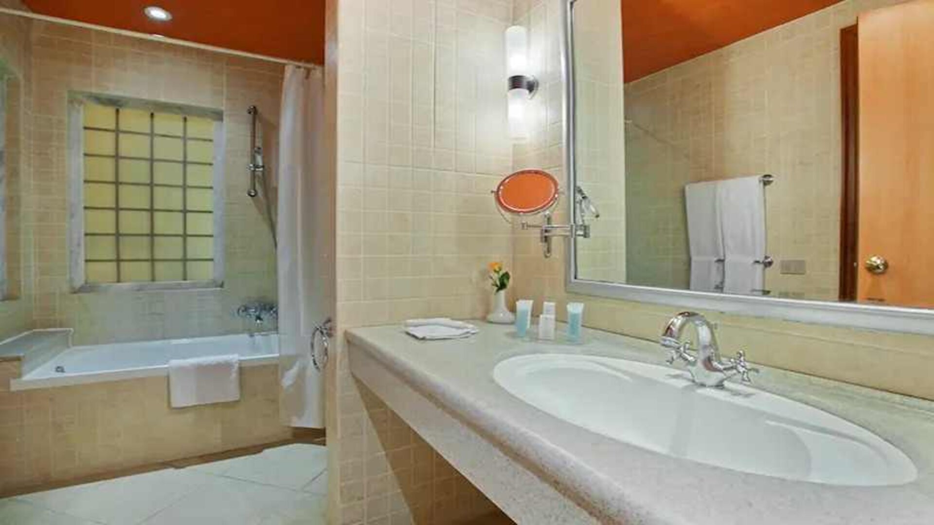 clean and spacious king bathroom with shower and bath combo at Hilton Alexandria Green Plaza.