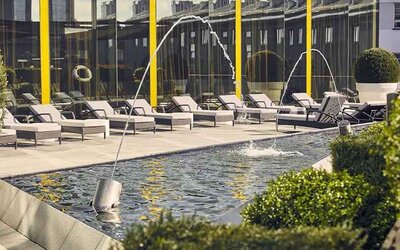 beautiful rooftop terrace with pool-fountain and sunbeds at Hilton Tallinn Park.
