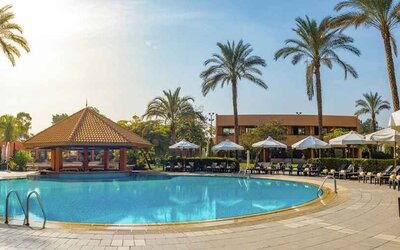stunning outdoor pool with sunbeds and umbrellas at Hilton Cairo Heliopolis.