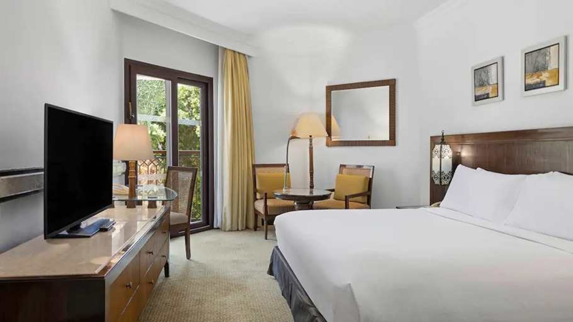 delux king room with TV and dining area at Hilton Luxor Resort & Spa.