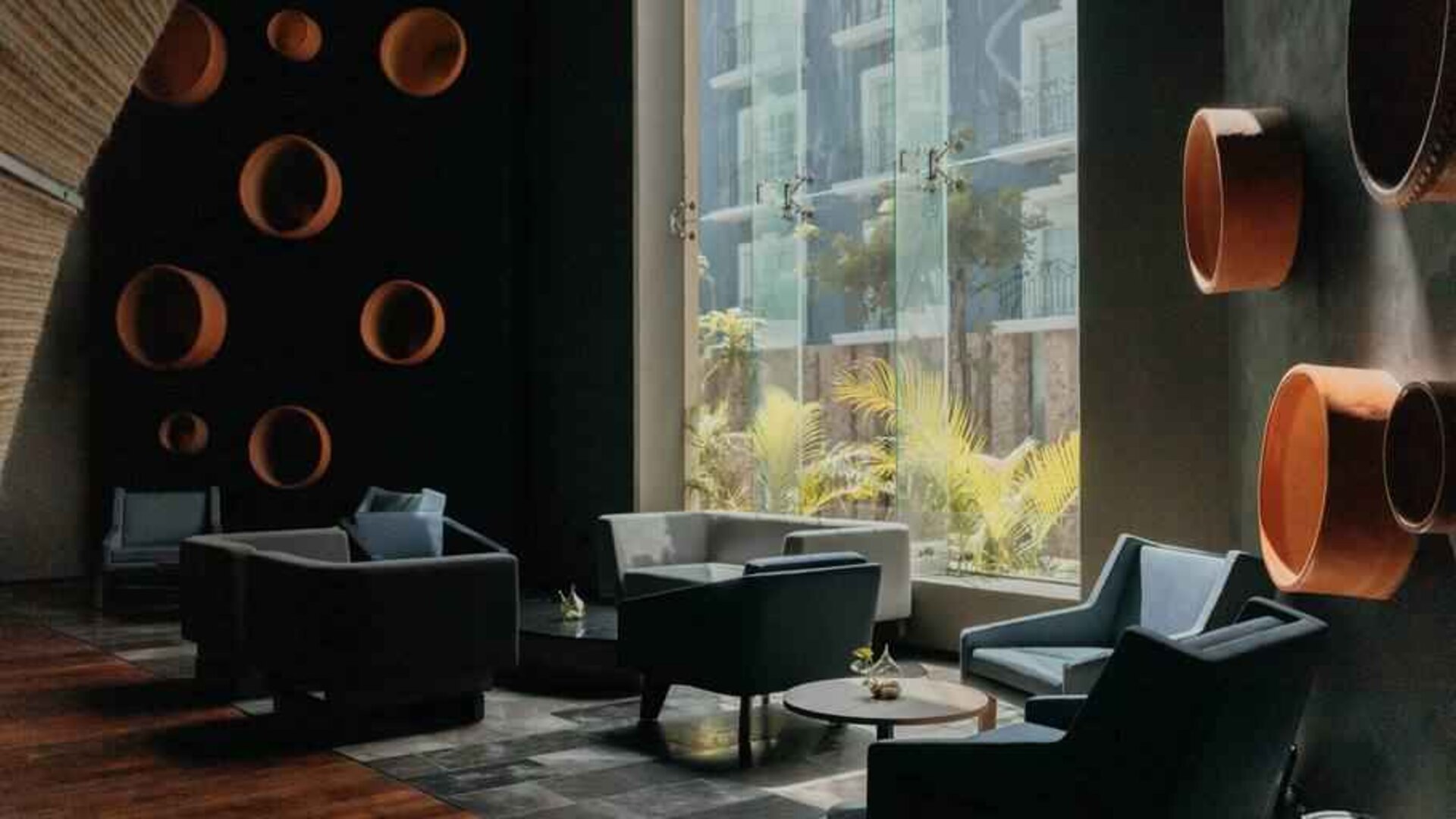 Seating area along the window at the Villa Mercedes Merida, Curio Collection by Hilton.