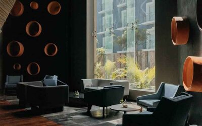 Seating area along the window at the Villa Mercedes Merida, Curio Collection by Hilton.