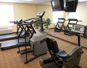 Well-equipped gym featuring treadmills, exercise equipment, and fitness amenities available for guest use at La Quinta Inn & Suites By Wyndham Sawgrass Mills.